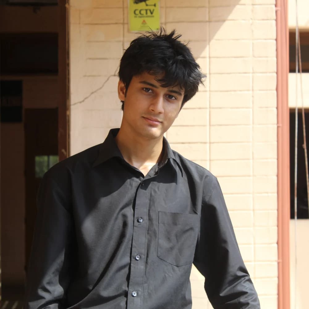 Rehan Sayyed standing outdoors in a dark shirt.